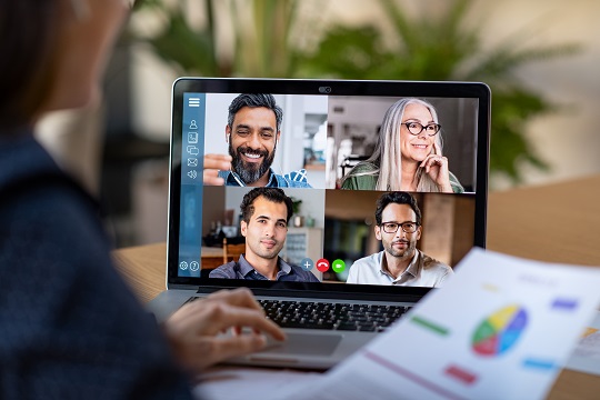 Online group classes, the screen is split into four and a participant is looking on