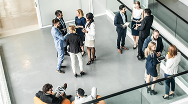 Arial view of a group of business and government officials standing and talking at an event