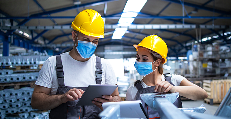 Industrial plant colleagues wear masks at work in pandemic