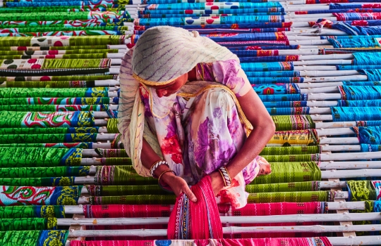 Indian woman working in a sari textile factory