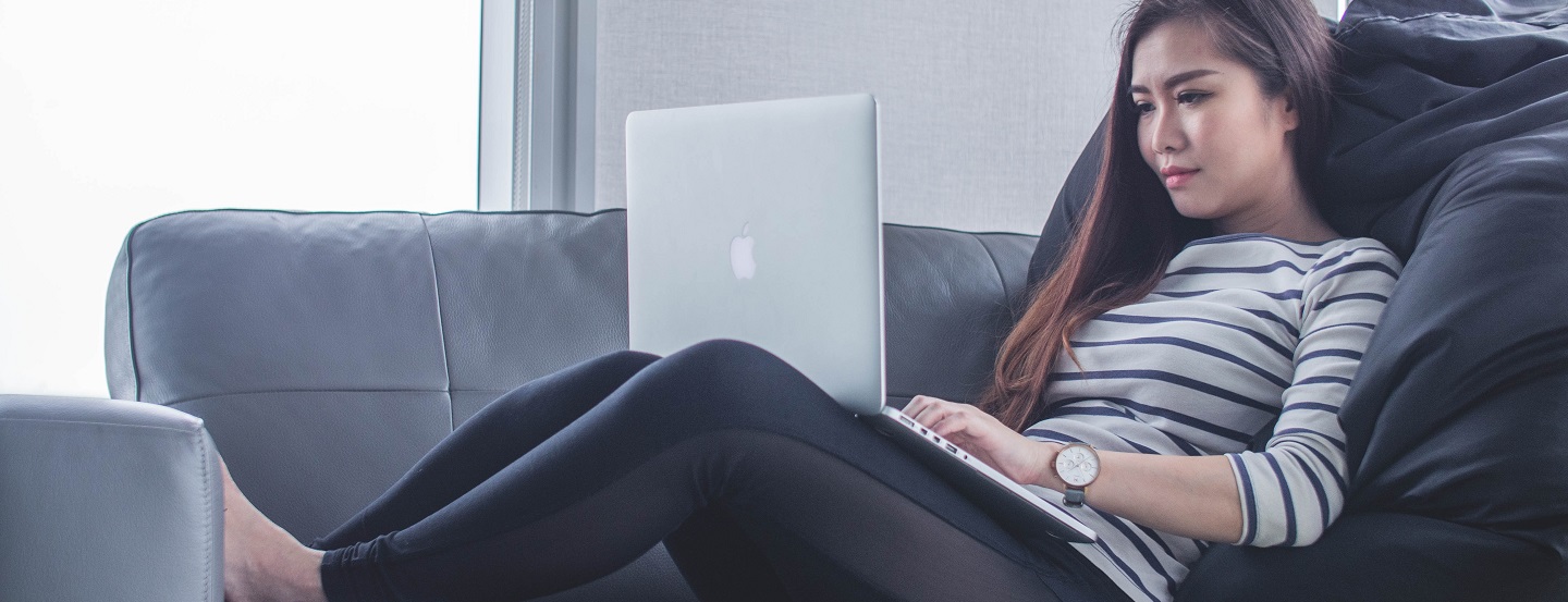 A woman works on her computer.