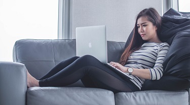 A woman works on her computer.