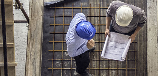 Construction workers following plans on a construction site