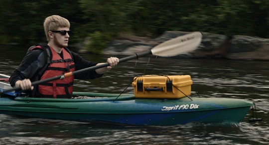 Man monitoring water while kayaking