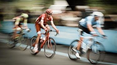 Slow-motion photo of three cyclists competing in a race