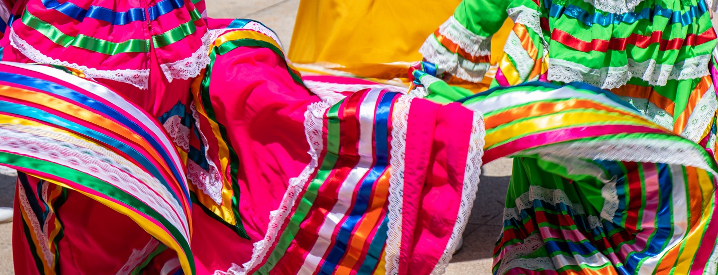 Colourful skirts twirl in a local marketplace. 