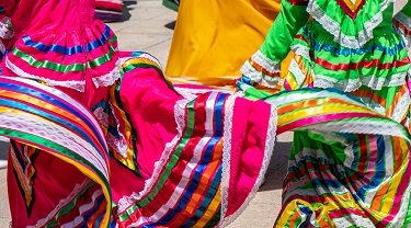 Colourful skirts twirl in a local marketplace. 