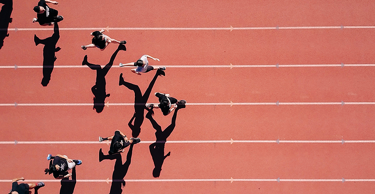 Viewed from above, athletes run on a track in a V formation.