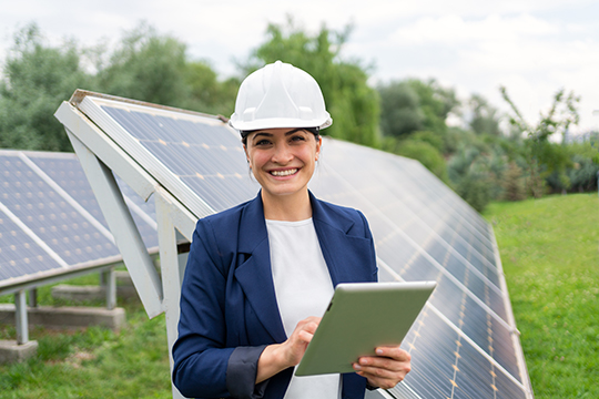 Image of engineer in front of solar panel