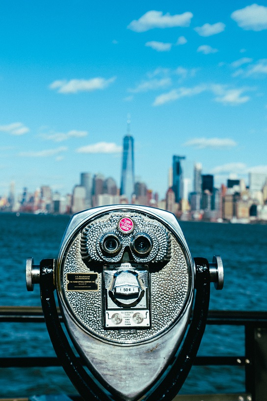 Binoculars look out over a cityscape