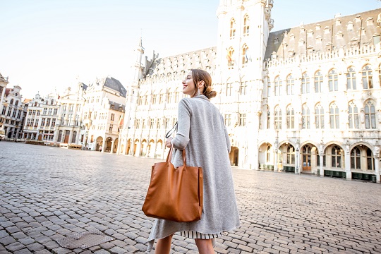 Businesswoman walks through Belgian square