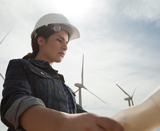 Young woman standing in front of a windmill