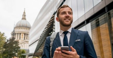 Businesspeople struggle to top of mountain