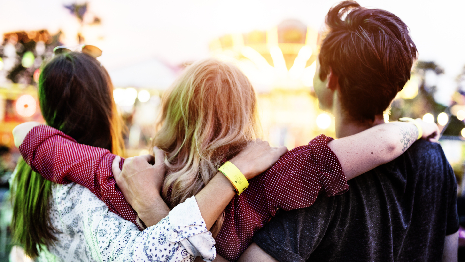 Three people linking arms