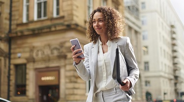 Canadian businesswoman in Europe smiles after landing deal.