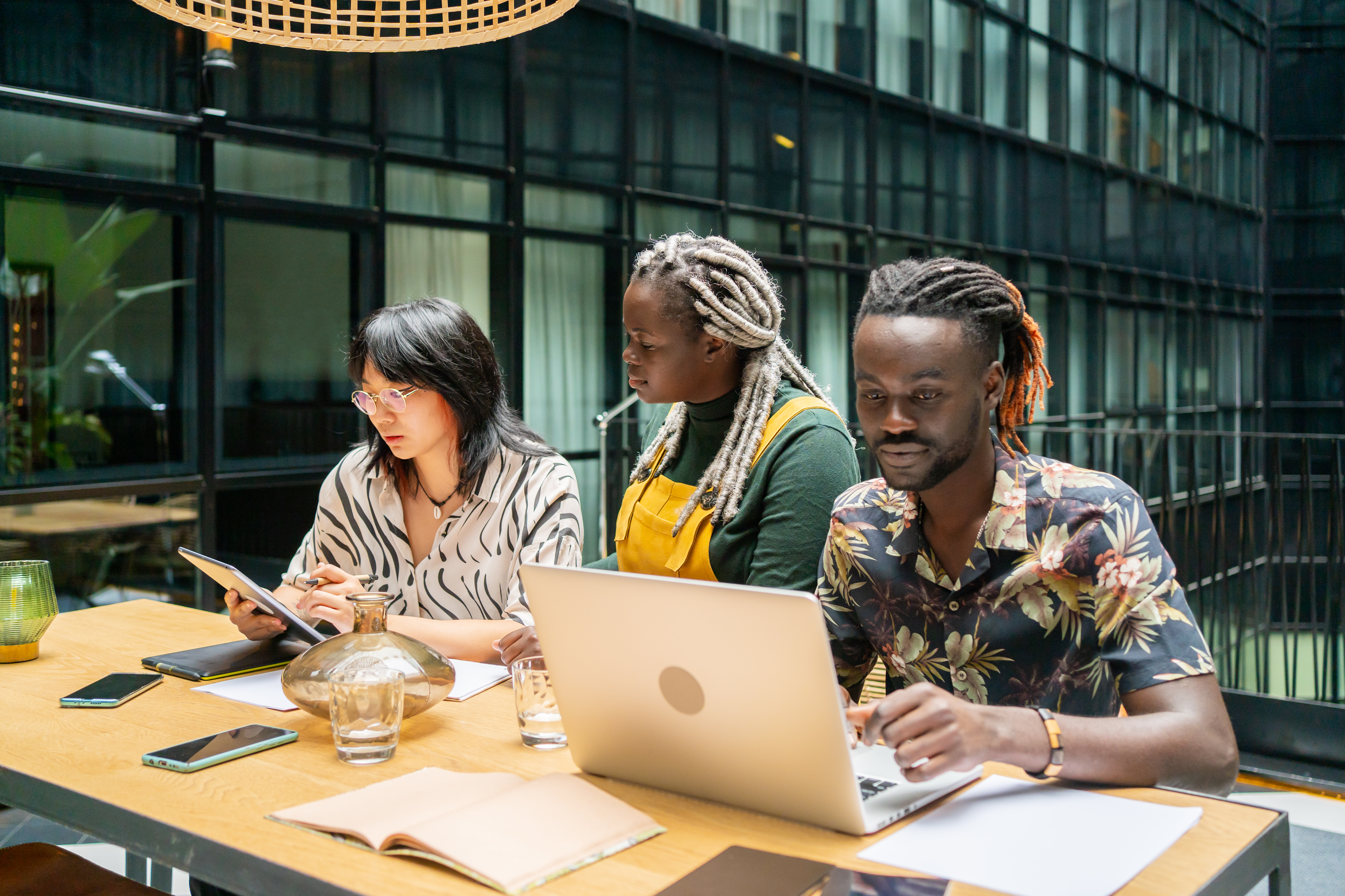 Group of three professionals collaborating in a modern office.