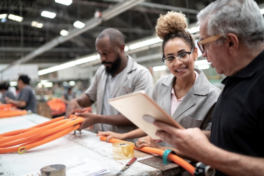 Black female working with her hands while looking over at a coworker to offer support