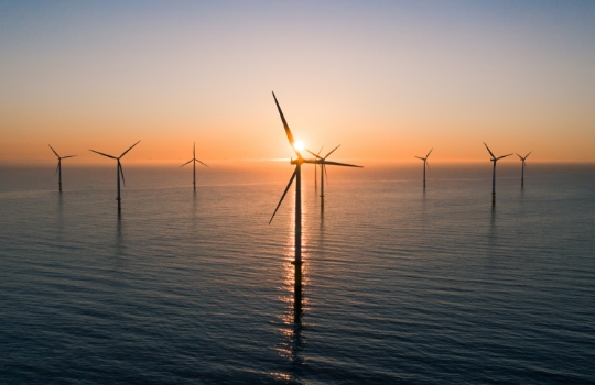 Offshore wind turbines at sunrise.