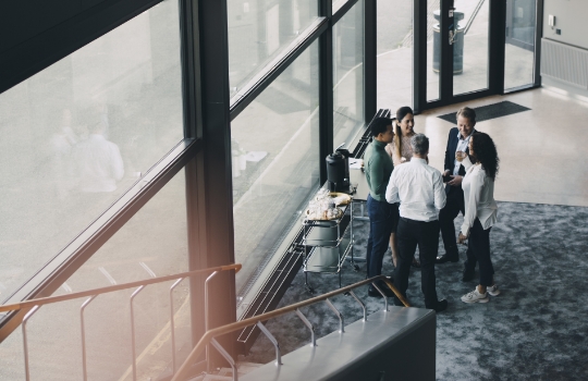 A group of professionals having a discussion in an office.