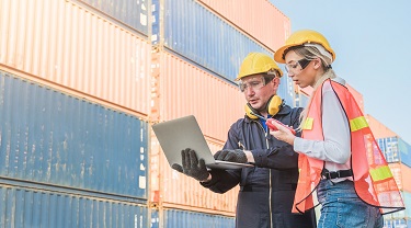 Workers are checking orders on a loading dock.