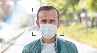 Man’s masked face with a facial grid overlaid on top of it