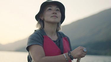 Femme qui pagaie et regarde à l’horizon