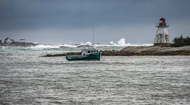 A fishing boat floats near the shore.