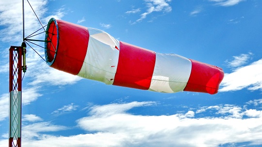 A wind sock flies in the stiff breeze.