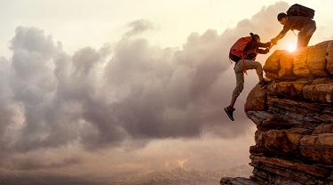 Mountain climbers manage a risky move
