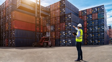 Port worker monitors shipping container logistics