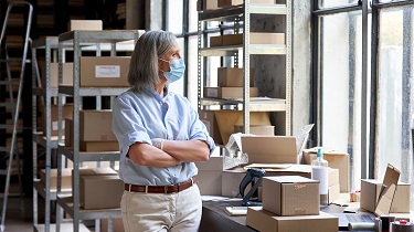 Mature female exporter prepares to ship goods