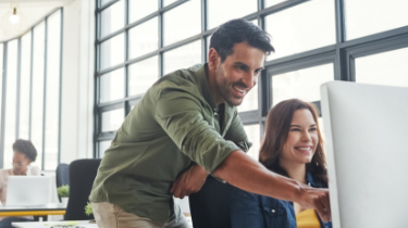 Man and woman at a desktop computer