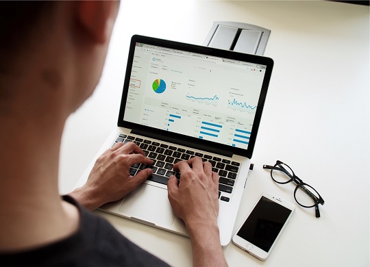 Man checking out his financials on his laptop