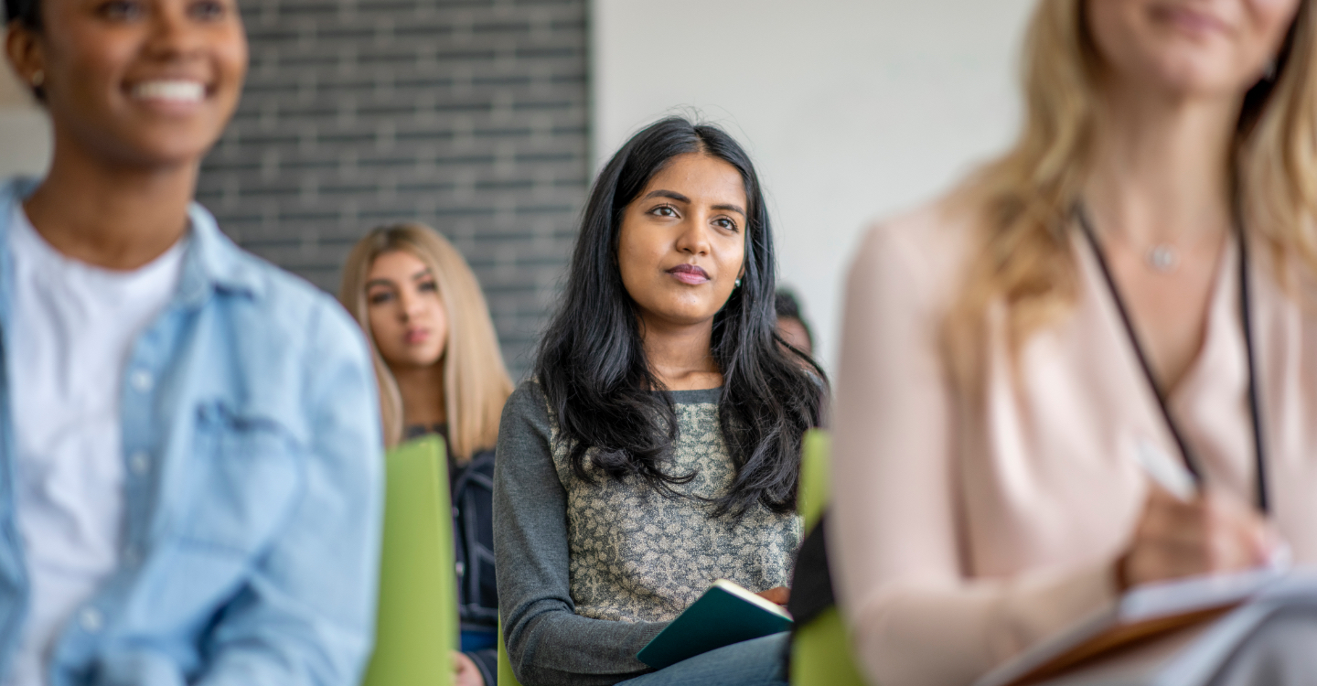 Woman in green sweater taking a class