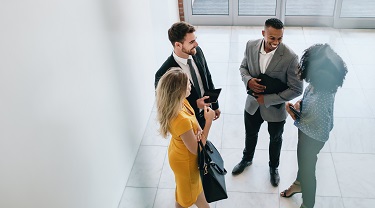 Group of young business professionals talking