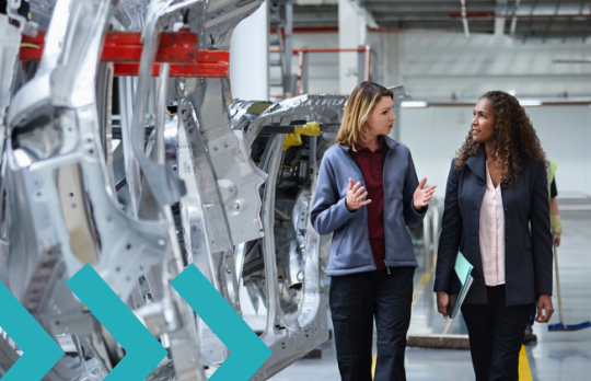 Women walking along assembly line