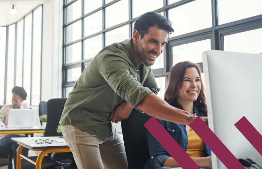 Man and woman at a desktop computer