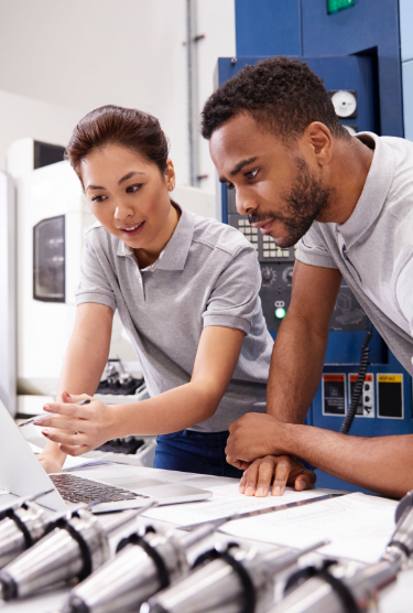 Woman and man in grey shirts at a laptop