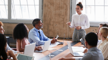 Woman making presentation to group at a boardroom table