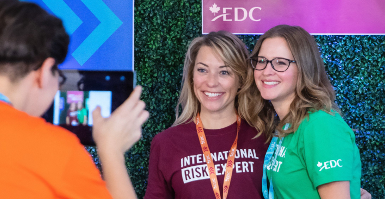 Two women being photographed at EDC event