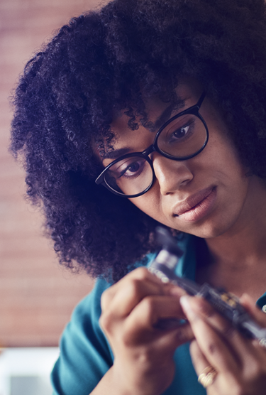 An entrepreneur examines her product