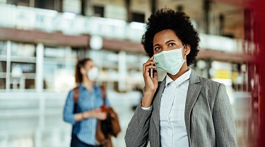 Une femme d’affaires porte un masque.