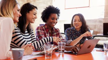 Group of female designers having meeting in modern office