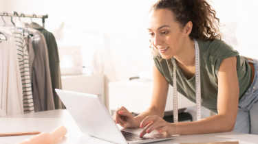 Woman with measuring tape and laptop