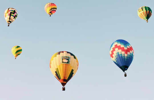 Hot air balloons floating through the sky