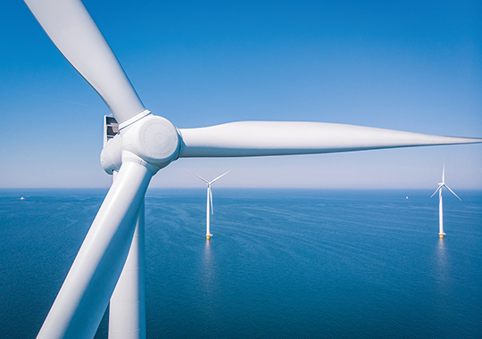 Aerial view of wind turbines on the water 