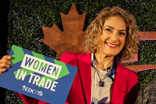 Jennifer Cooke holds sign for women in trade
