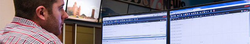 A man looking at computer screens for ways to use innovation to be competitive.