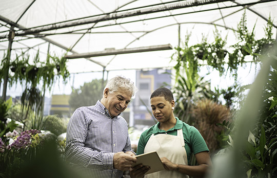 Image de deux personnes dans une serre représentant les changements climatiques et les populations